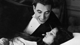 Film still from Dracula (1931). Image of Dracula leaning over a sleeping woman.