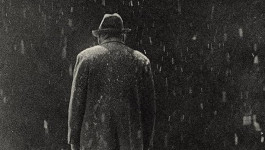 Film still from Ikiru (1952). Image of a man walking in the rain.