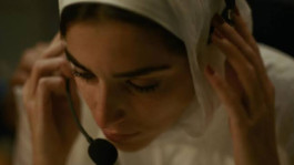 Film still from The Voice of Hind Rajab (2025). Image of a woman with a headset.