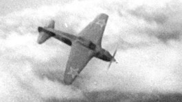 Film still from Wings (1985). Image of a World War II airplane in the air.
